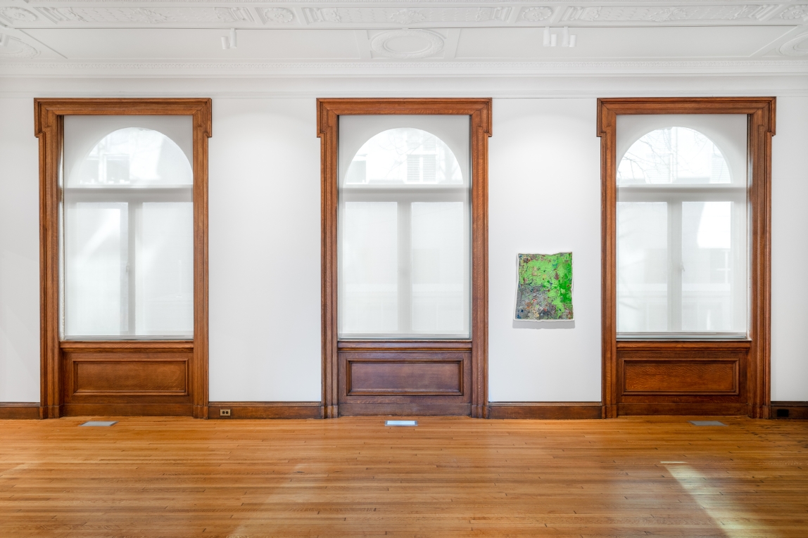 Installation view of a framed painting amidst three large windows