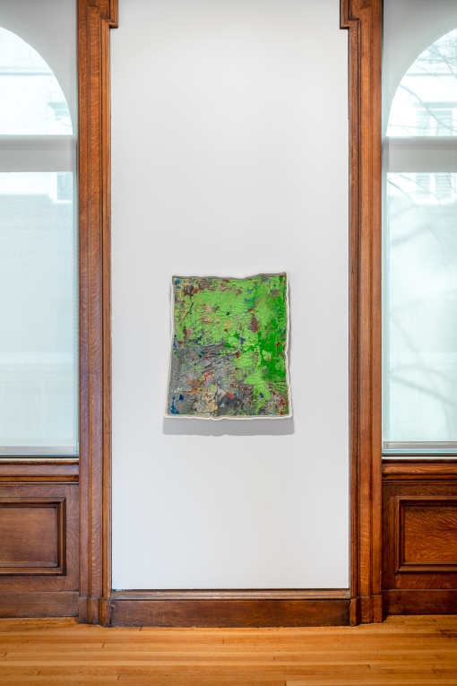 Installation view of framed painting between two window frames