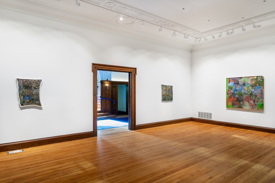 Installation view of Gallery B with three paintings hanging on two walls