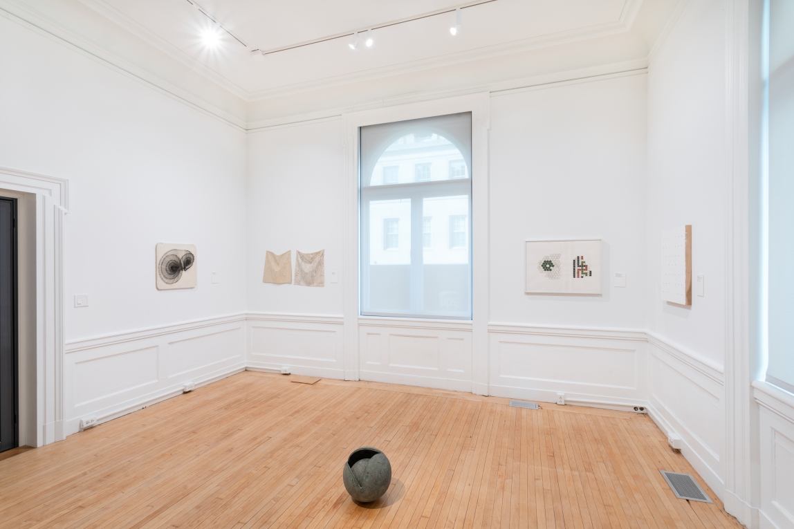 Installation view of Gallery A with 4 works on the wall and spherical sculpture on the ground
