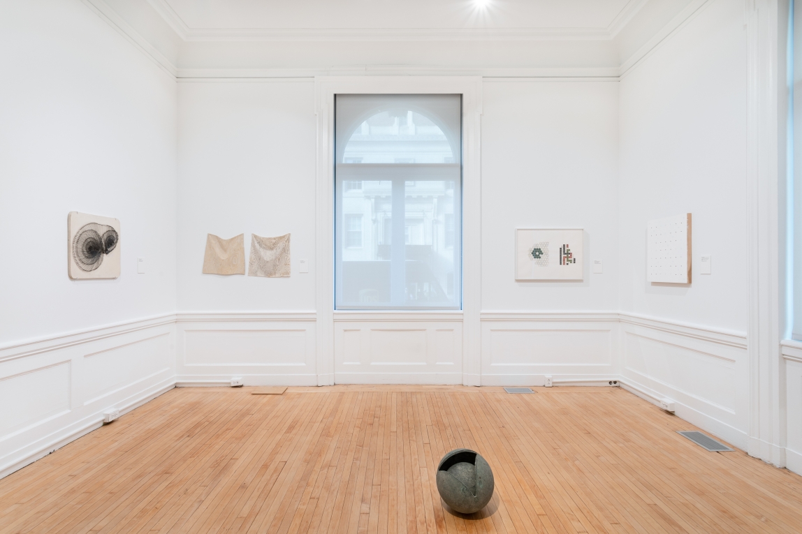 Installation view of gallery A with 4 different works hanging on the walls and sculpture on floor