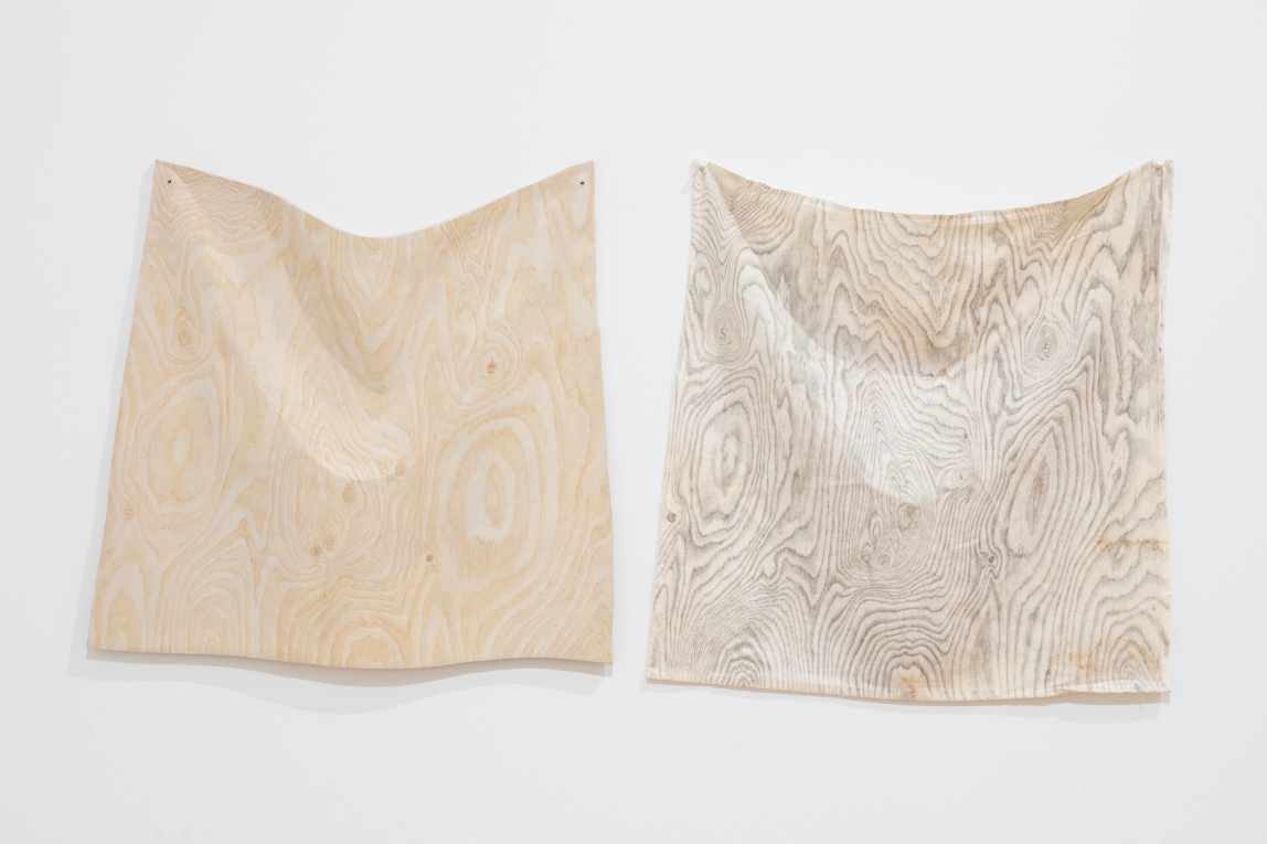 Installation view of work with one ceramic piece resembling a cloth and one cloth piece resembling the ceramic