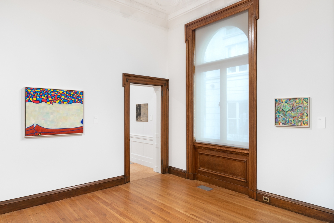 Installation view of Gallery B with two paintings hanging on two different walls