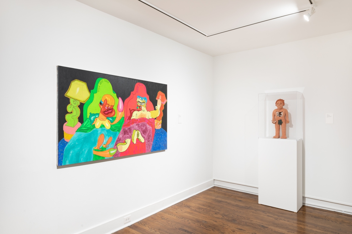 Installation view of neon painting and human-formed sculpture on pedestal nearby