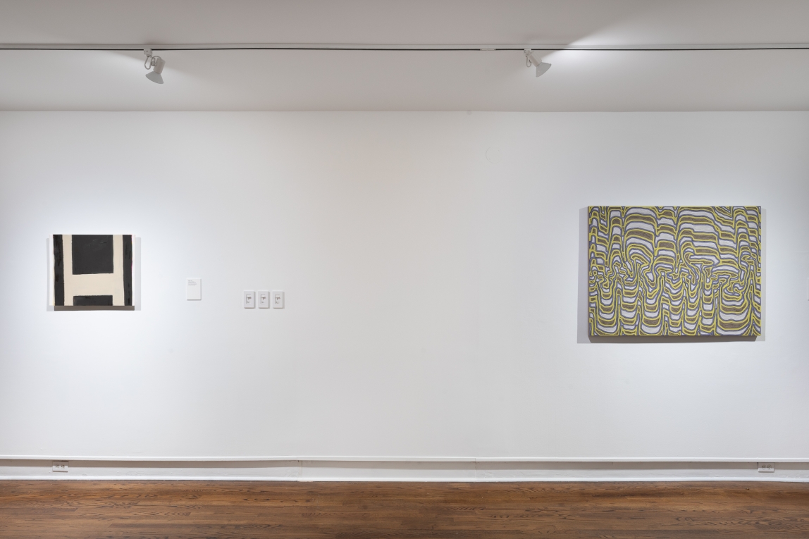 Installation view of two works, one small painted one, one larger with wavy lines