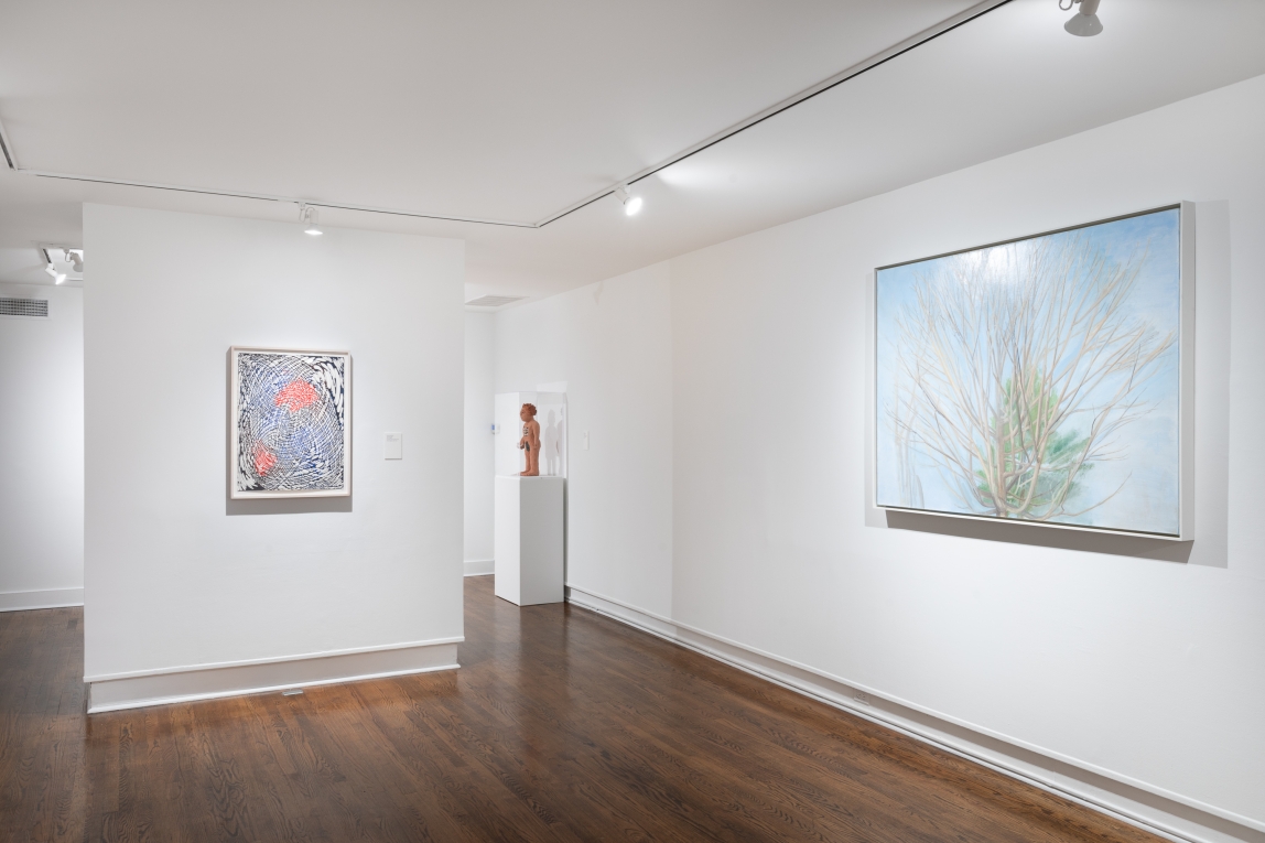 Installation view showing two framed works and a sculpture in background