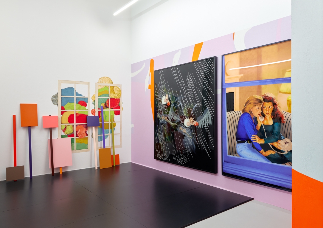 Installation view of two large paintings on mural wall with signs leaning in background