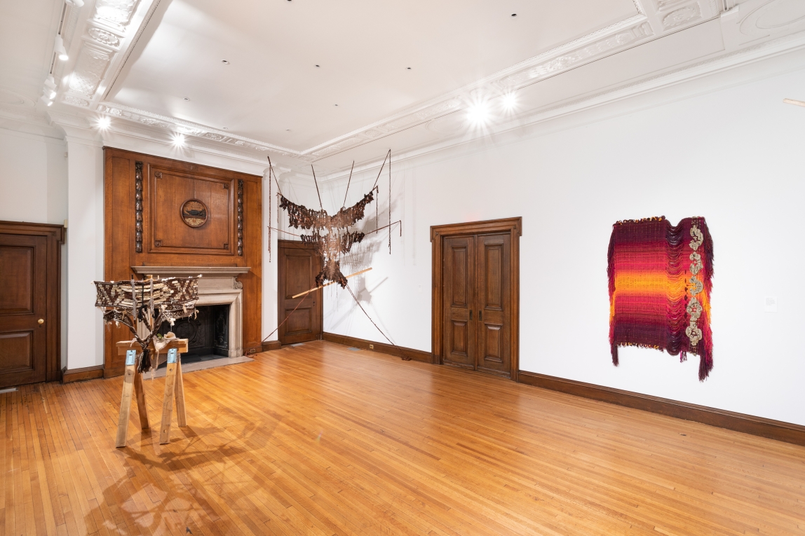 Installation view of gallery with three fiber artworks on display