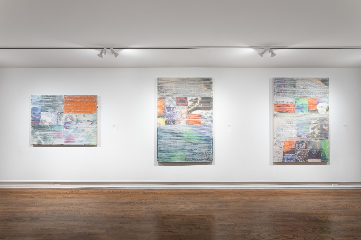Installation view of three woven artworks hanging in a row