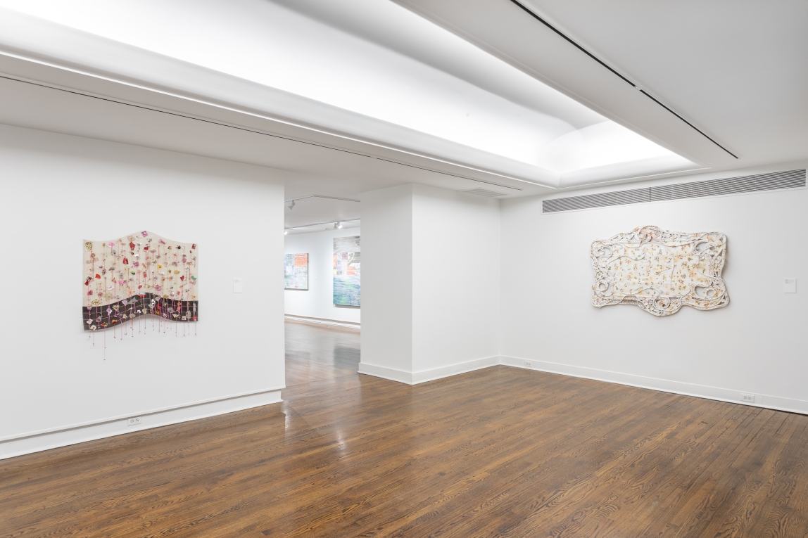 Installation view of two fiber works hanging on two different walls