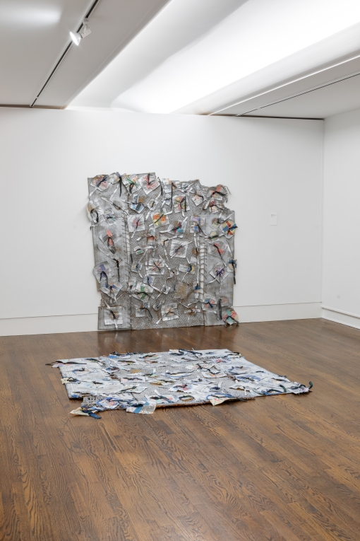 Installation view of two corresponding silver fiber artworks, one hung on the wall and the other laid on the floor beneath