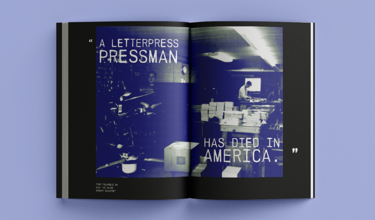 an open bookon a periwinkle background. the pages are open to a poster graphic reading "a letterpress pressman has died in america" split across the two pages in a white type across a deep blue image of a print shop