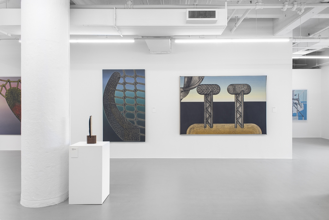 installation image of two large colorful paintings in background and sculpture on pedestal in foreground