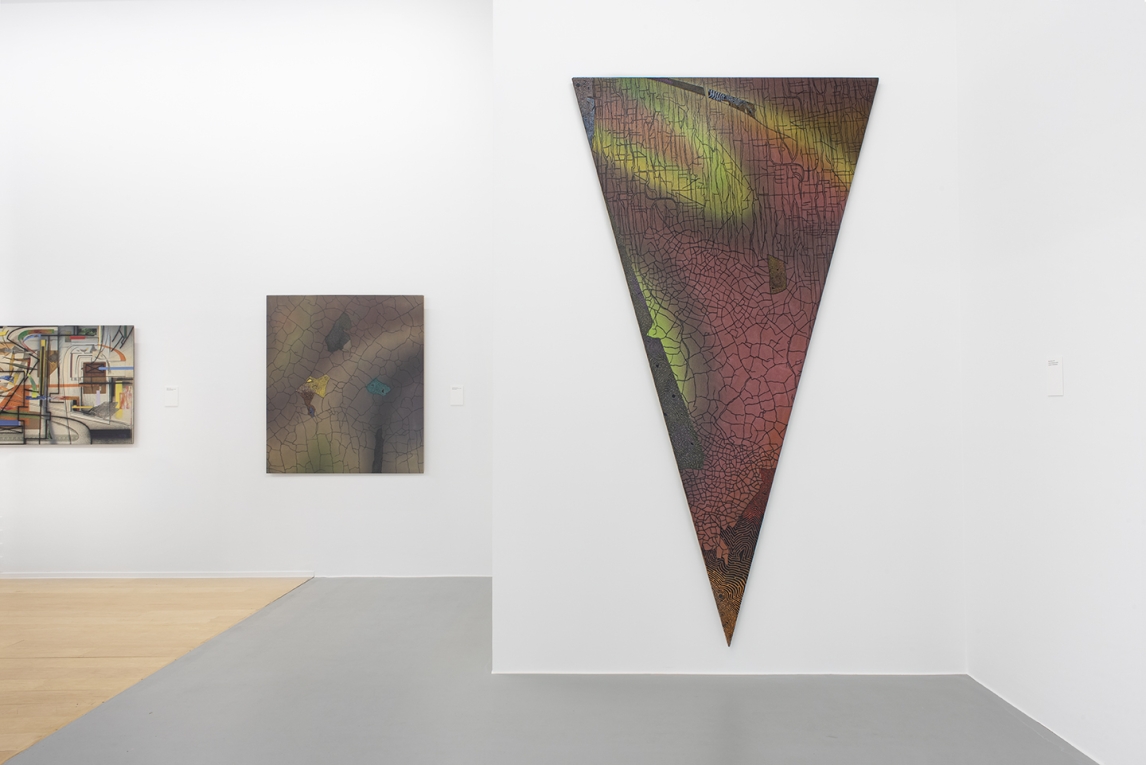 Large triangle shaped painting in foreground and two other paintings in background