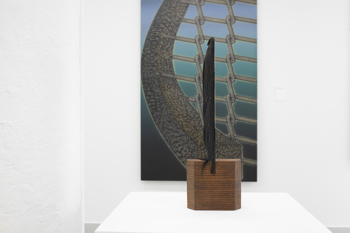 Installation image with sculpture on pedestal in foreground, aligned with painting in background