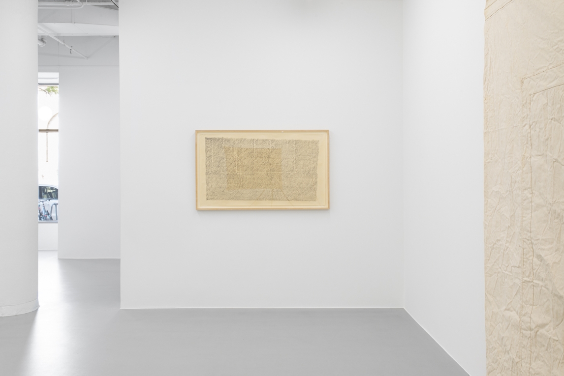 Installation view of framed rubbing artwork on white wall