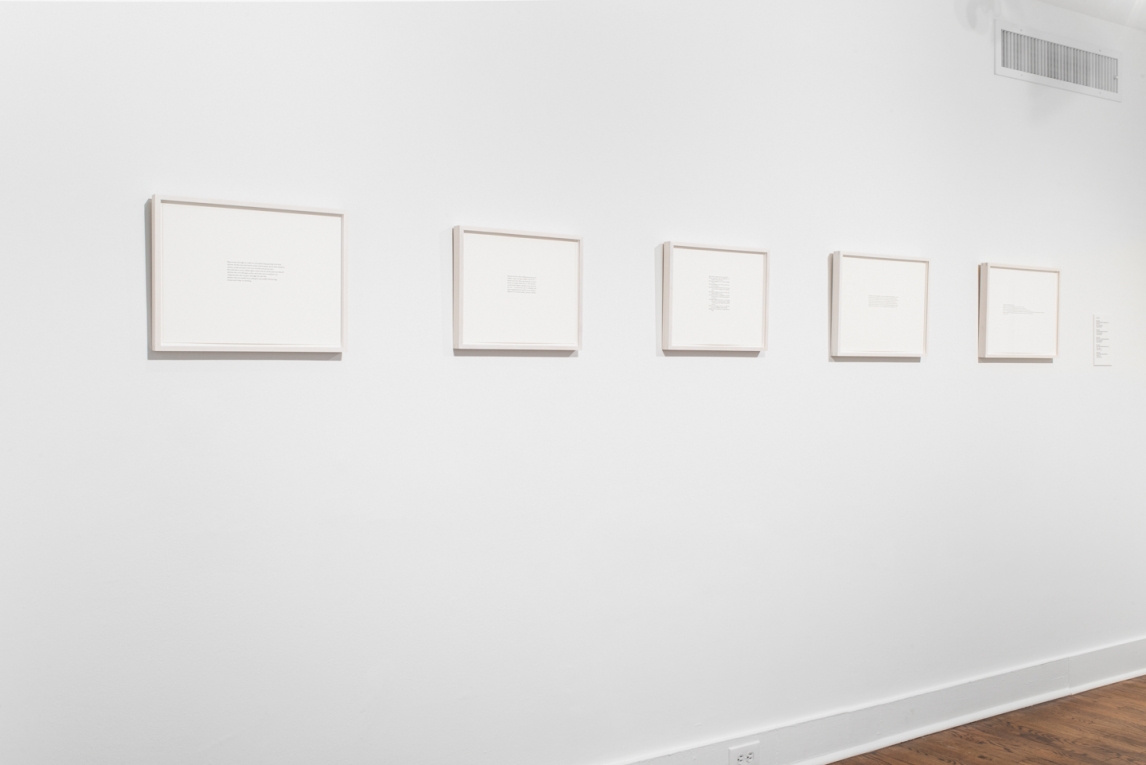 Installation view of five works in pencil composed of text