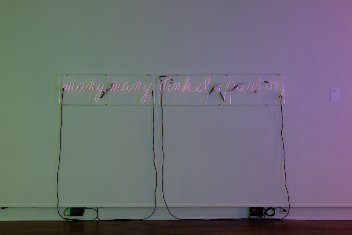 Installation view of neon artwork composed of words