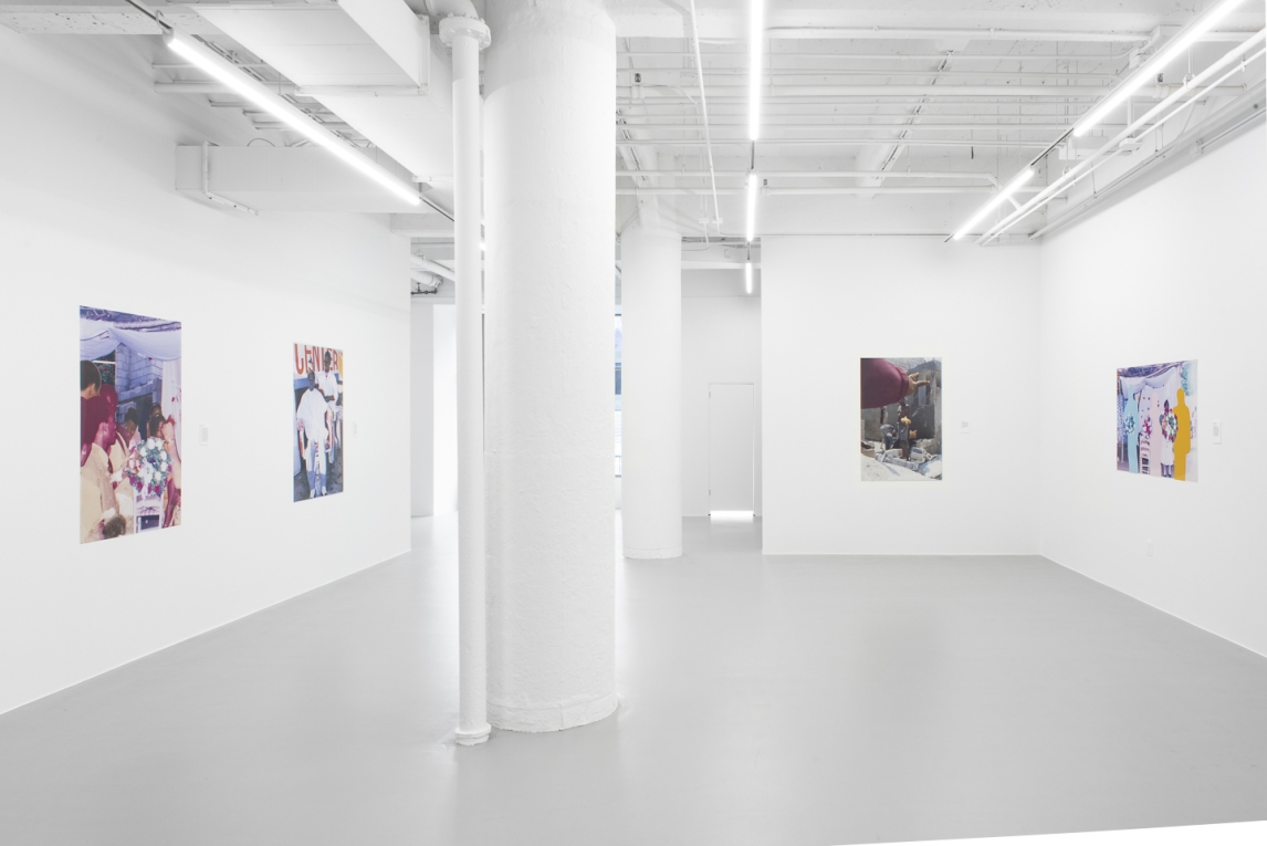 Installation view of gallery with vinyl images displayed against white walls