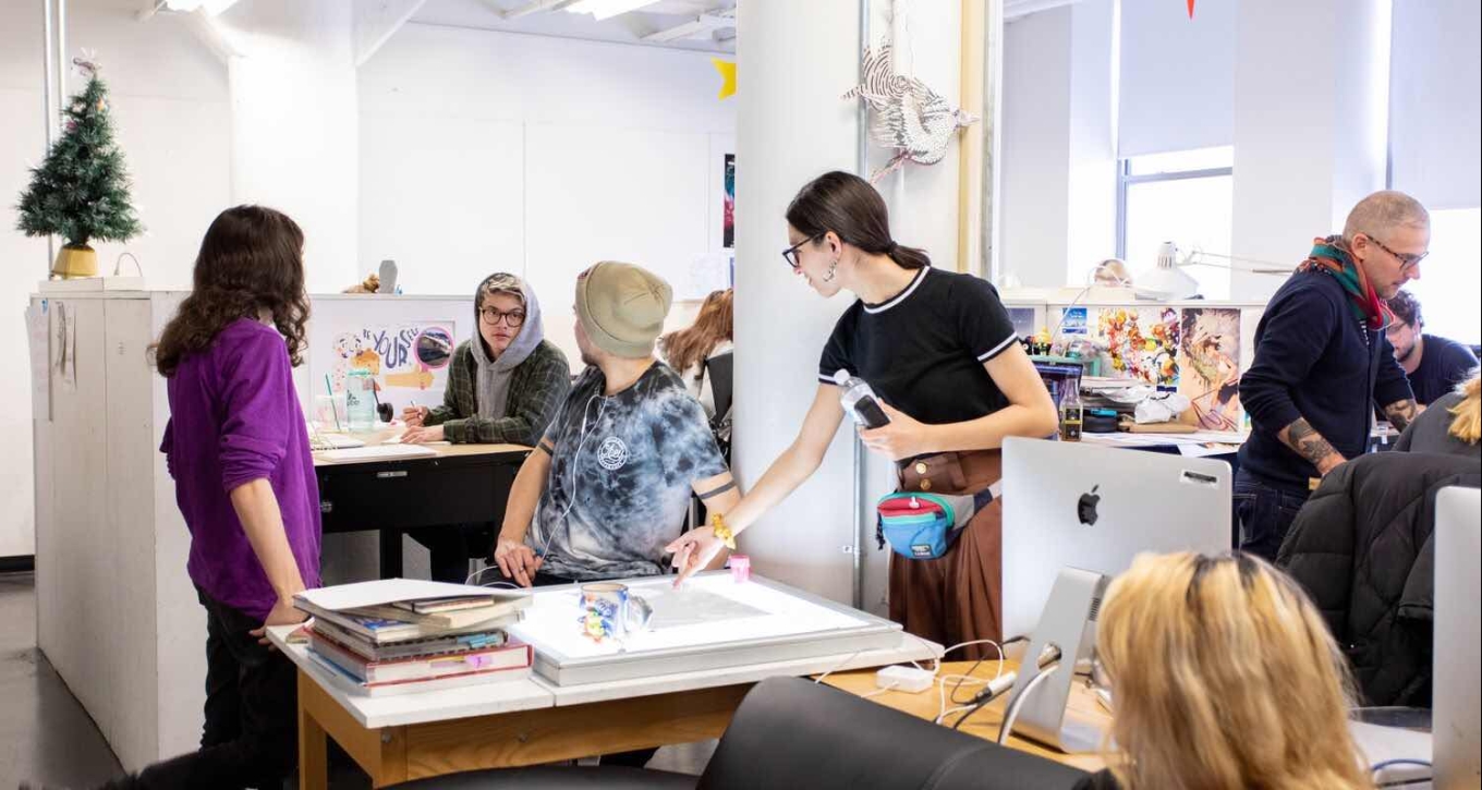 Group of students working together in an illustration class 
