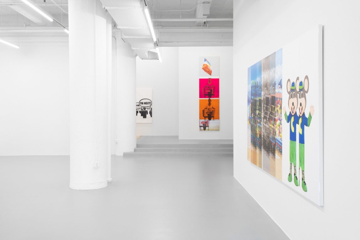 Installation view of artworks hanging in white gallery
