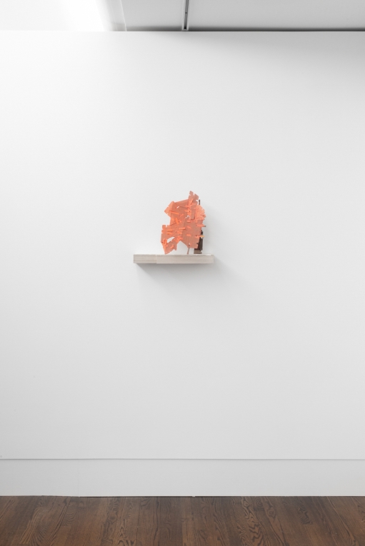 Sculpture on shelf attached to wall