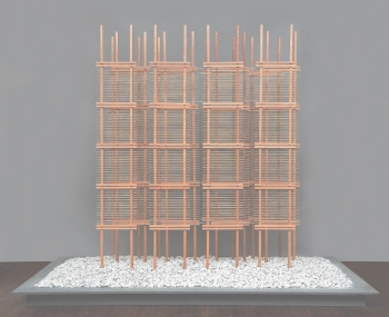 A minimal sculpture made with weathered oak and brass rods on white marble stones that resembles a large city building