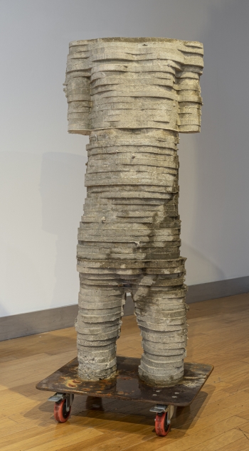 A cast cement figure sculpture that was made from a digitally altered scan of the body of the artist that is hollow and filled with water so that it continually sweats through to the outer surface