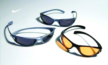 Three pairs of Nike sunglasses and two of them have dark lenses and the other has yellow lenses with the Nike logo in the top left corner