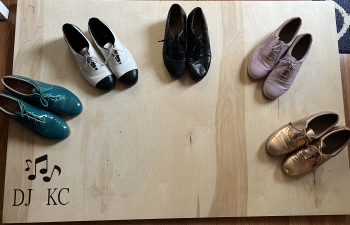 Four pairs of dance shoes in the individual colors of teal and white and black and black and lavender and golda semicircle 