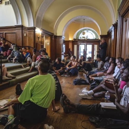 Students of the School for Temporary Liveness gather in and around the stairwell of the Philadelphia Art Alliance for Study Hall with nora chipaumire and Isabel Lewis, 2019. Photo: Constance Mensh.