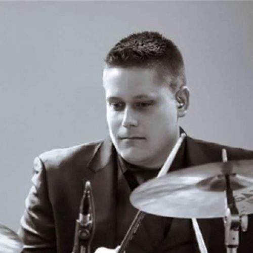Alum Andrew Kruc (MAT '12) plays his drum set.