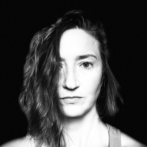 A black and white headshot of Katherine Orloff against a black background