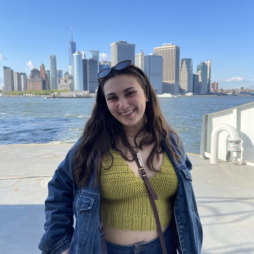 A photo of Sofia Marchese in front of the Philadelphia skyline