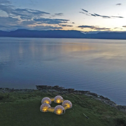 Five domelike pods sitting on a coastline