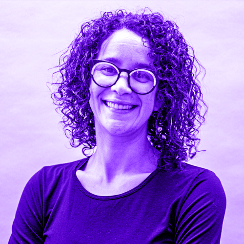 headshot of Angela Jones-O'Brien overlaid with a violet gradient. Angela is wearing a black shirt and gold black horn-rimmed glasses with a white semiciruclar inlay. her hair is curly and she has a big smile.  