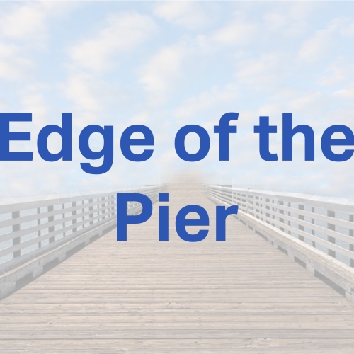 A photo of a pier with a cloudy sky with blue text that reads Edge of the Pier