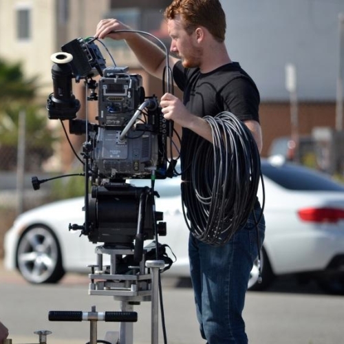 Andrew Wheeler adjusting film camera on location
