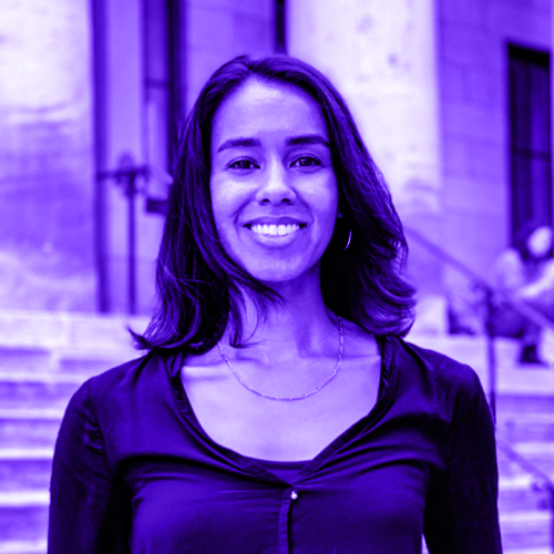 headshot of melanie romay overlaid with a violet hue. melanie is wearing a black blouse against a background of hamilton hall's stairs. 
