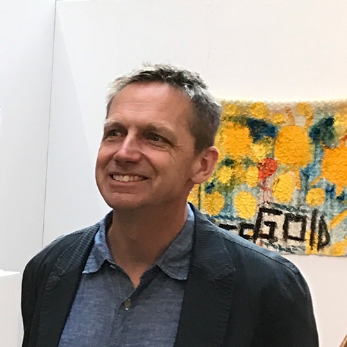 Michael Grothusen; medium closeup of a man wearing a denim shirt and a blue jacket
