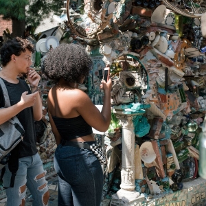 Students take a photograph during the Dive into Philly mural arts tour