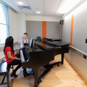 A student takes a private piano lesson with faculty member AJ Luca.