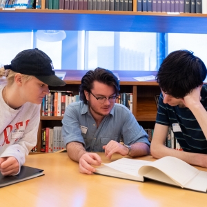 Three students read a script together in the Writers Guild of America West during their trip to Los Angeles, CA.