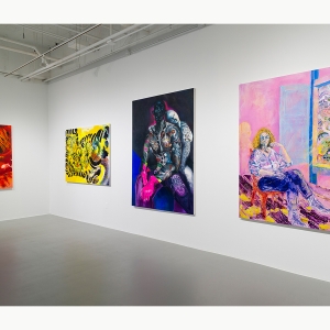 A set of four paintings hanging on a wall in a gallery.