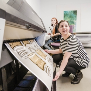 A student prints their large format poster