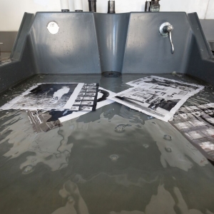 A sink with photos soaking in liquid