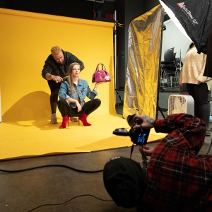 Students work with a model for a photo shoot in the Photography studio