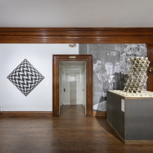 Invisible City Exhibition, 2nd Floor Landing: model of Anne Tyng's and Louis Kahn's City Tower on stand to the left, a geometric painting on the wall to the right