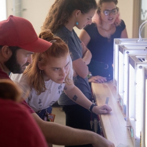 Students look inside a 3D printer