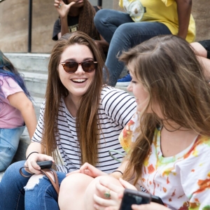 Students sit on the steps of Hamilton and hang out